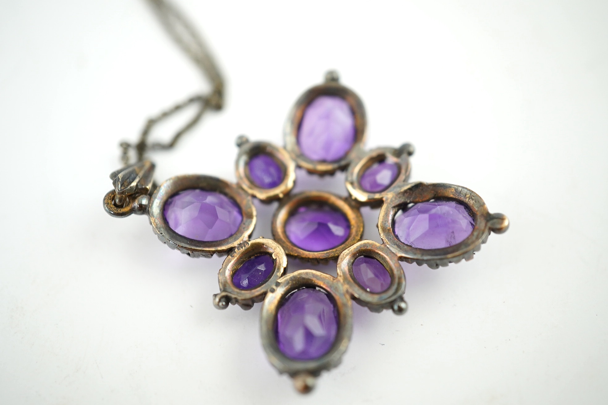 An amethyst pendant, 40mm, on a 9ct gold chain. Condition - fair